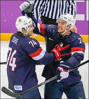 T.J. Oshie, left, is congratulated by Ryan Callahan after scoring the winning goal in a shootout win against Russia.