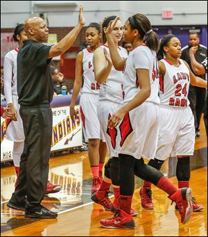 Rogers coach Lamar Smith high-fives Keasja Peace near the end of Saturday’s City League championship game against Start. The Rams improved to 18-4.