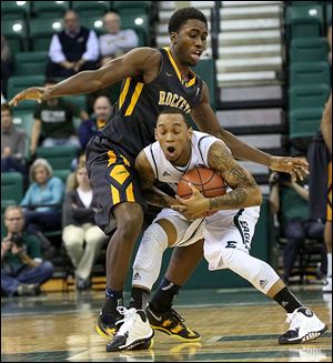 Toledo's Justin Drummond fouls Eastern Michigan's  Mike Talley. Drummond eventually fouled out.