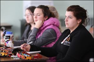 First-semester nursing student Hanna McLaughlin, right, takes notes during a presentation by Martha Gallagher, a nurse and associate professor at Lourdes who led the January trip to Haiti.