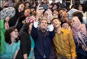 John Kerry takes a selfie with students before his speech Sunday in Jakarta, Indonesia. He said despite many looming disasters related to future climate change, there’s still time to act and tackle the problem.