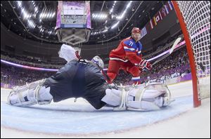 Russia’s Ilya Kovalchuk flips the puck past Slovakia goaltender Jan Laco to score in the shootout.