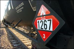 A warning placard appears on a tank car carrying crude oil near a terminal in Trenton, N.D. Experts say it’s become impossible to send oil-hauling trains without passing major population centers.