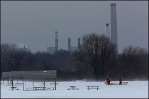 Members of a search and rescue team comb the ice on Lake Erie at Maumee Bay State Park.