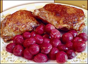 Pomegranate-glazed chicken thighs with roasted red grapes.