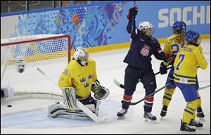Lyndsey Fry, center, of the United States reacts after a goal by teammate Megan Bozek against Sweden during the second period of the women's semifinal ice hockey game at Shayba Arena in Sochi, Russia.