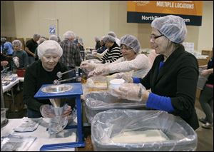 Members of NorthRidge Church pack food for malnourished children in Novi, Mich. The 2 million meals will be sent to El Salvador, Haiti, and the Philippines.