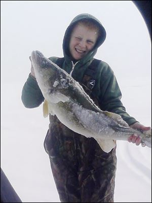 Byron Grochowski, 12, a 7th grader at Anthony Wayne Junior High, caught a 31-inch walleye recently while ice fishing on Lake Erie.