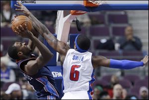 Detroit Pistons forward Josh Smith (6) reaches in and fouls Charlotte Bobcats forward Michael Kidd-Gilchrist (14).