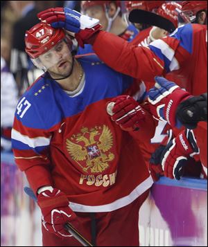 Russia forward Alexander Radulov is congratulated by teammates after scoring against Norway in the third period today in Sochi, Russia. 
