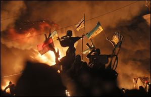Monuments to Kiev's founders burn as anti-government protesters clash with riot police in Kiev's Independence Square, the epicenter of the country's current unrest,  Kiev, Ukraine, Tuesday.