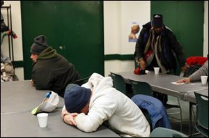 Homeless men gather in the lounge of St. Paul's Community Center Tuesday morning.
