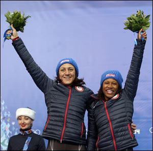 Lauryn Williams, right, and Elana Meyers celebrate receiving their silver medals in  women's bobsled competition at the 2014 Winter Olympics this week.