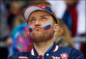 A Russian hockey fan reacts to his home team's loss at the end a men's quarterfinal against Finland.