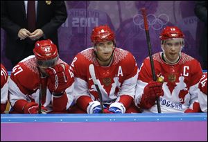 Russia forwards Alexander Radulov, from left, Alexander Ovechkin and Pavel Datsyuk watch play against Finland late in the third period today in the men's ice hockey quarterfinal in Sochi, Russia.