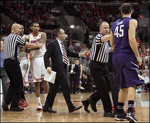 Referees and coaches separate Northwestern's Nikola Cerina, right, and Ohio State's LaQuinton Ross during a second-half scuffle on Wednesday. Cerina and Ross were both ejected from the game.