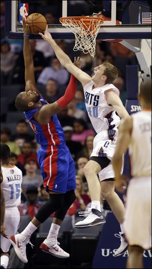 Detroit Pistons' Greg Monroe, left,  gets his shot blocked by Charlotte Bobcats' Cody Zeller during the first half.