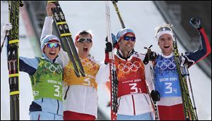 From left, Norway's Haavard Klemetsen, Magnus Krog, Magnus Hovdal Moan and Joergen Graabak, celebrate winning the gold during the cross-country portion of the Nordic combined Gundersen large hill team competition at the 2014 Winter Olympics, today in Krasnaya Polyana, Russia.