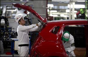 Employees at work in the new multibillion-dollar Honda car plant in Celaya, in the central Mexican state of Guanajuato.