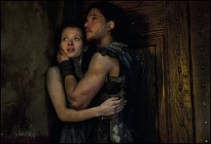 Emily Browning, left, and Kit Harington in a scene from 'Pompeii.'
