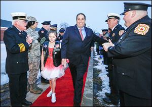 Uniformed personnel cheer Marlee Eckert, 10, as she and Dave Miramontes, her grandfather, walk the red carpet to Waterville Primary School’s Winter Ball.