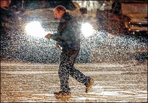 A man makes his way through the parking lot of Gibsonburg High School after the Ottawa Hills basketball game on Feb. 4 in Gibsonburg, Ohio.