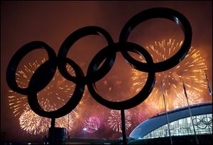 The Olympic Rings are silhouetted as fireworks light up the sky during the closing ceremonies at the 2014 Sochi Winter Olympics on Sunday Russia.