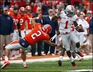 Ohio State cornerback Bradley Roby avoids Illinois quarterback Nathan Scheelhaase as he returns an interception a 63 yards for a touchdown during a Nov. 16, 2013, game in Champaign, Ill.