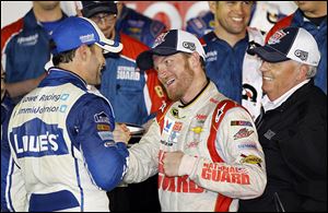 Dale Earnhardt, Jr., center, celebrates in Victory Lane with teammate Jimmie Johnson, left, and team owner Rick Hendrick.