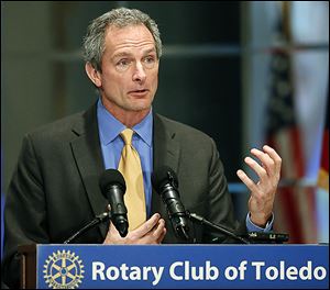 Michael Stenger, regional director of the investment management division of Goldman Sachs Group Inc., speaks  at the monthly Rotary Club meeting Monday at the Park Inn in Toledo.