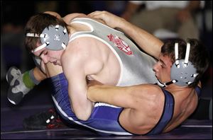 Central Catholic’s Alex Mossing controls Fremont Ross’ Jordan Weissinger in the 152-pound championship match at the Three Rivers Athletic Conference tournament. Mossing, a district champion, is 32-3 this season. He was a state champ at 138 last year.