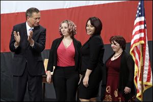 Ohio Gov. John Kasich, from left, introduces Amanda Berry, Gina DeJesus and Michelle Knight during his State of the State address at the Performing Arts Center Monday.