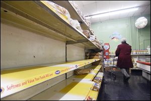 The bread shelves at Buehler's Market in Chattanooga, Tenn. are mostly empty. Owner Charles Morton says he has been in the business for 50 years, and the bread and milk sales have always increased in snow.