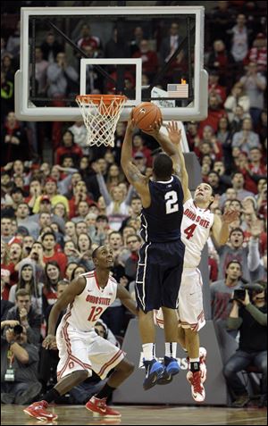 Penn State's DJ Newbill (2) makes the game-winning shot as Ohio State's Aaron Craft (4) and Sam Thompson (12) defend in their Jan. 29 matchup. The Buckeyes seek to even the score when they face the upset minded Nittany Lions again. 