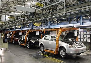 Chevrolet Cobalts move along the line at the Lordstown Assembly Plant in northeast Ohio.  The U.S. government’s auto safety watchdog agency is looking into whether General Motors was slow to report problems with ignition switches that led to a massive recall after 13 deaths and 31 crashes.