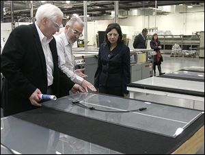 Michael Cicak, left, of Willard & Kelsey and manager Vince Poleo guide Labor Secretary Hilda Solis, one of several key Democrats to visit the firm, in 2011. 