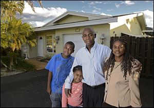 Ganel Appolon, with his family, from left, Stanley, Jessica, and his wife, Maude, lost his home three years ago in the economic downturn. They recently purchased this home in Fort Lauderdale, Fla. Housing experts say that  these so-called ‘boomerang buyers’ are key to sustaining the housing recovery. 