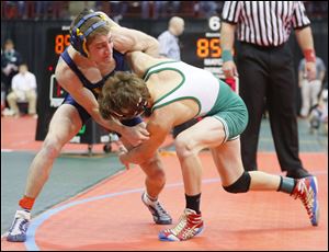 Evan Ulinski of Woodmore, left, fends off a shot by Delta wrestler Jake Spiess in their Division III 113-pound match during the championship semi-final round of the 77th Annual State Wrestling Individual Tournament.