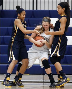 Notre Dame's Mariah Copeland, left, and Jayda Worthy swarm Perrysburg's Allex Brown, who had 15 points and 10 rebounds.