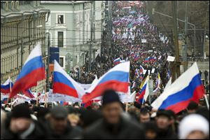 More than ten thousand pro-Kremlin demonstrators many holding Russian flags march Sunday in central Moscow to express support for the latest developments in Russian-Ukrainian relations.