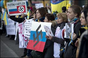 Ukrainians living in Italy voice outrage over Russia’s military intervention in the Crimea region during a protest at the Russian embassy in Rome.