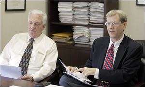 Ronald Rothenbuhler, Chairman of the Lucas County Board of Elections, left, and board member Jon Stainbrook visit offices of The Blade in 2013.