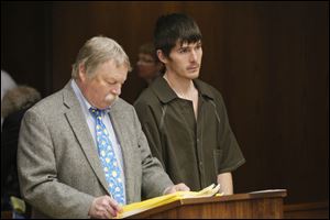 Dustin Werner, 25, stands with public defender James MacHarg at his arraignment Monday in Toledo.