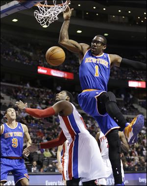 New York Knicks forward Amar'e Stoudemire (1) dunks on Detroit Pistons center Andre Drummond (0) during the first half.