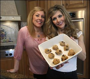 Sarah Shew, left, and Kendra Tinney show off quinoa chocolate chip cookies, which Mrs. Tinney made with TV’s Dr. Oz in a show that will air today.