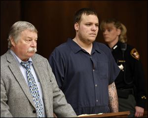 Anthony Fesh, right, appears in Toledo Municipal Court today with public defender James MacHarg.