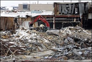 Demolition crews tear down the Woodville Mall in Northwood. The shopping center was closed in December, 2011, because of serious problems such as mold, asbestos, and water damage. 