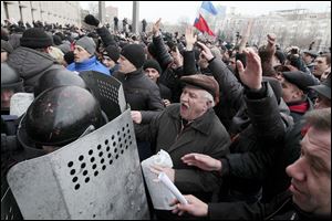 Demonstrators break police ranks to enter the regional administrative building in Donetsk, Ukraine. Hundreds of demonstrators waving Russian flags have stormed the government building in the eastern Ukraine. 