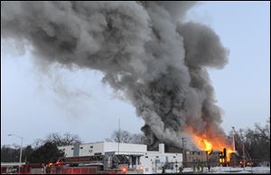 Firefighters battle a large fire at an apartment building in Detroit today.