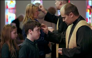 Michael Fahncke, 12, receives ashes.